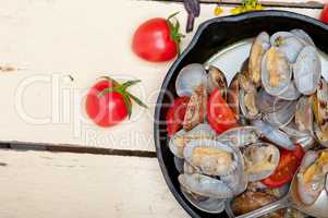 fresh clams on an iron skillet