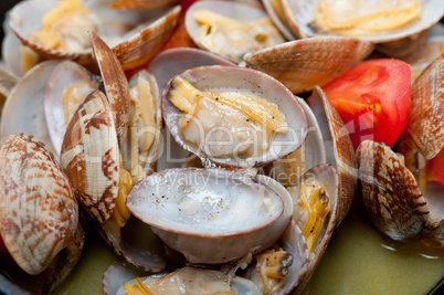 fresh clams on an iron skillet