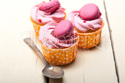 pink berry cream cupcake with macaroon on top