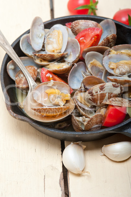 fresh clams on an iron skillet