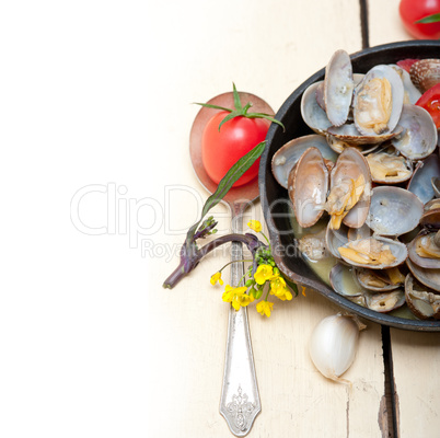 fresh clams on an iron skillet