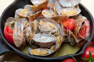 fresh clams on an iron skillet