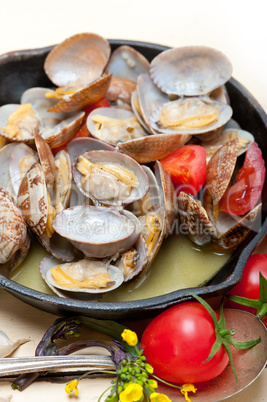 fresh clams on an iron skillet