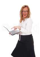 Business woman laughing at laptop.
