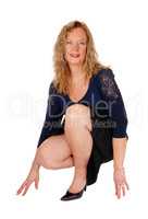Lovely woman crouching on floor.