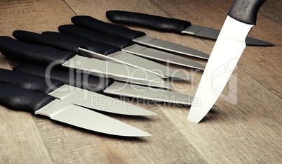 set kitchen knifes on wooden board render