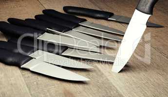 set kitchen knifes on wooden board render