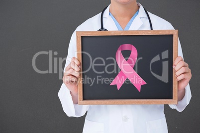 Composite image of doctor holding board with aids symbol