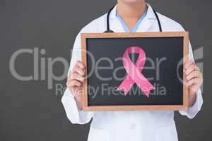 Composite image of doctor holding board with aids symbol