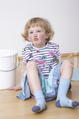 Young blond girl while sitting