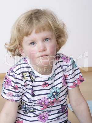 Young blond girl while sitting