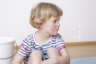 Young blond girl while sitting