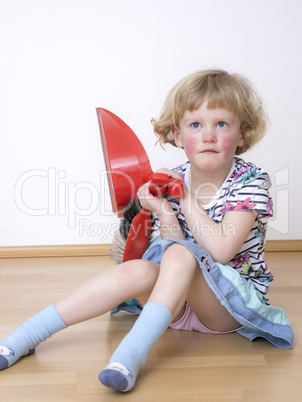 Young blond girl while sitting