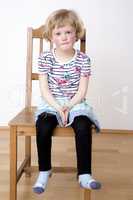 Young blond girl while sitting