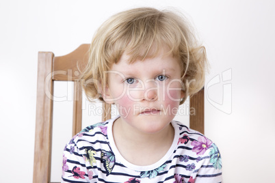 Young blond girl while sitting