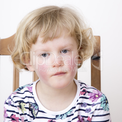 Young blond girl while sitting