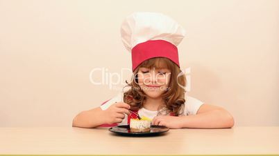 hungry little girl cook eat cake