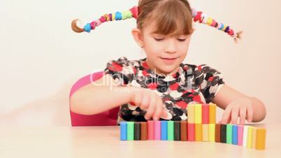 little girl play with plasticine