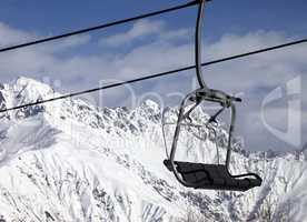 Chair lift in snowy mountains at nice sunny day