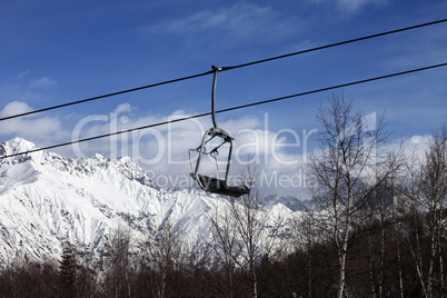 Chair lift in snowy mountains at nice day