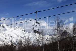 Chair lift in snowy mountains at nice day