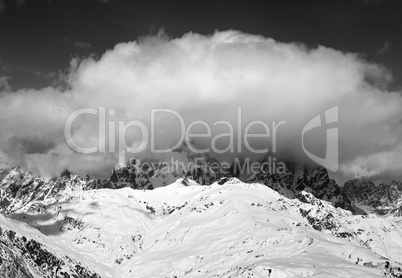 Black and white view on Mount Ushba in clouds at winter