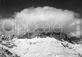 Black and white view on Mount Ushba in clouds at winter