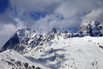 Snowy rocks in haze at sunny day