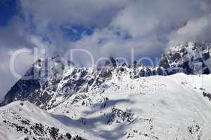 Snowy rocks in haze at sunny day