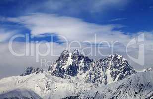 Mounts Ushba and Chatyn and blue sky with clouds