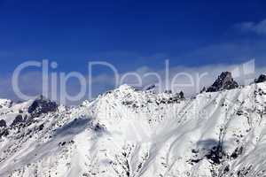 View on snowy mountains in haze at sunny day