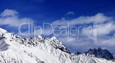 Panoramic view on snowy mountains at sun day