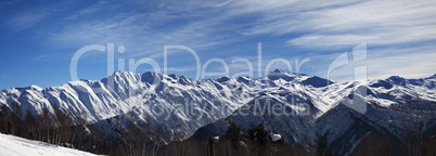 Panoramic view on sunlight snowy mountains in nice morning