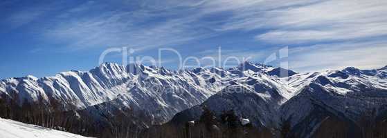 Panoramic view on sunlight snowy mountains in nice morning
