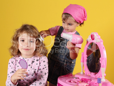 little girls play hairdressers