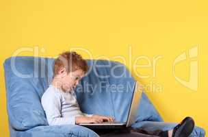 boy typing on laptop