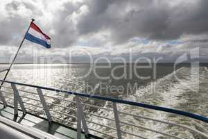 Wadden Sea with Dutch flag.