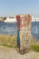 Old weathered and beautifully colored mooring pole.