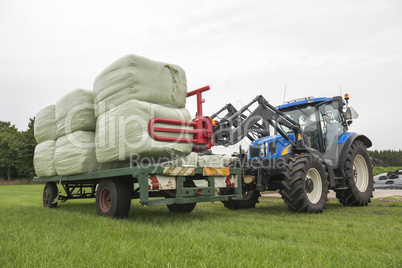 Agriculture loading of plastic hay bales.