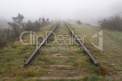 Old railway line shrouded in the fog..