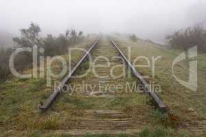 Old railway line shrouded in the fog..