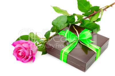 Present and rose isolated on white background