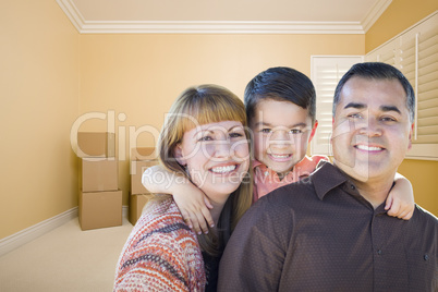 Young Mixed Race Family In Room With Moving Boxes