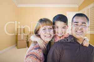 Young Mixed Race Family In Room With Moving Boxes