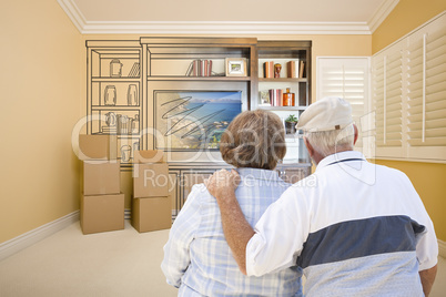 Senior Couple Looking At Drawing of Entertainment Unit In Room
