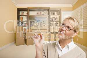 Female Holding Pencil In Room With Drawing of Entertainment Unit