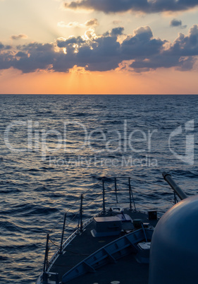 german navy cannon on sunset in the sea