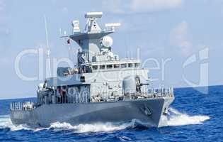 warship drives fast in ocean