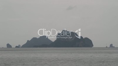 lonely sailboat against a background of the islands. Ao Nang beach, Krabi, Thailand