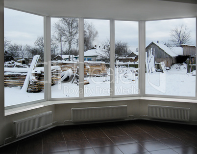wide window overlooking the winter rural landscape